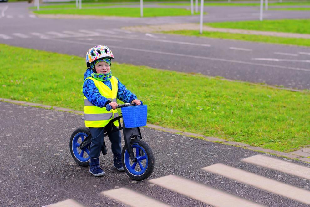 Young cyclist stopped at pedestrian crossing